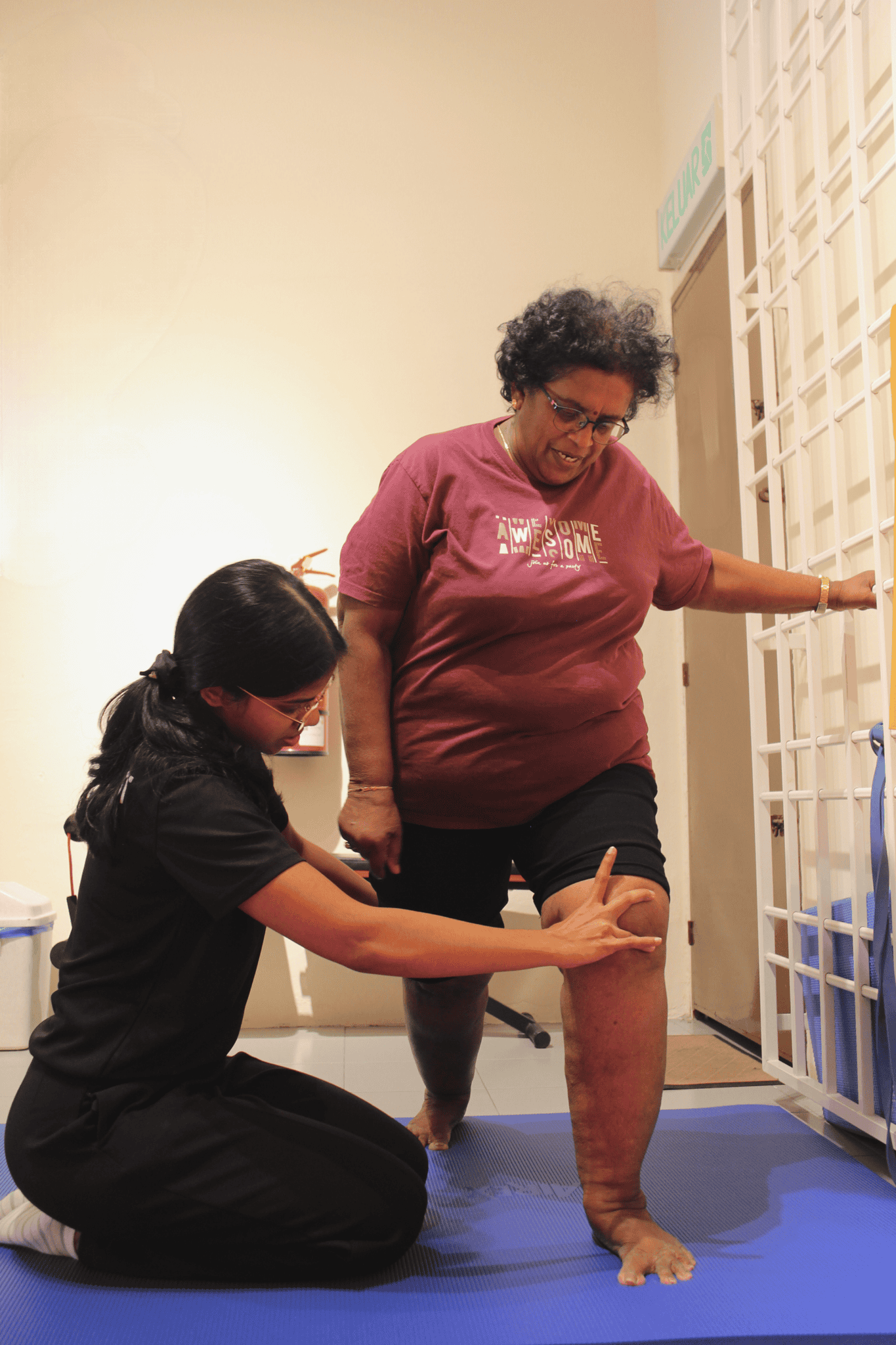 Woman receiving physical therapy for leg mobility improvement.